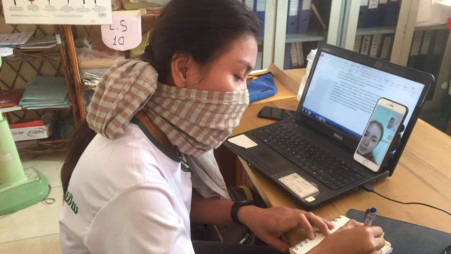 A Room to Read mentor speaks to a student via video call as part of the Girls’ Education Program work in Cambodia. Source: Room to Read/Bloomberg