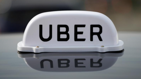 FILE PHOTO: The Logo of taxi company Uber is seen on the roof of a private hire taxi in Liverpool, Britain, April 15, 2019. REUTERS/Phil Noble