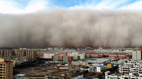 A town in northwest China being engulfed in a sandstorm. Photo: Collected