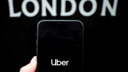 The Uber logo is displayed on a mobile phone in this picture illustration taken November 25, 2019. REUTERS/Hannah McKay/Illustration