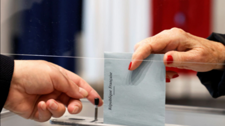 A voter casts her ballot at a polling station in Le Touquet, France for the second round of regional elections on June 27, 2021. Ludovic Marin/Pool via REUTERS