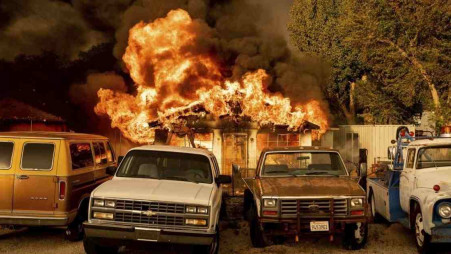 Flames consume a home as the Sugar Fire, part of the Beckwourth Complex Fire, tears through Doyle, Calif., on Saturday, July 10, 2021. Pushed by heavy winds amid a heat wave, the fire came out of the hills and destroyed multiple residences in central Doyle. Photo: AP via UNB