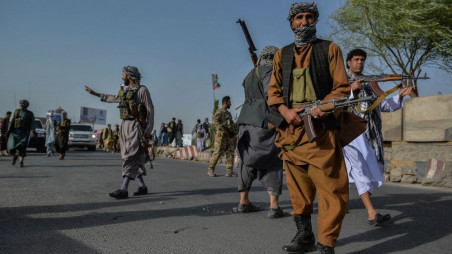 Afghan security personnel and Afghan militia fighting against the Taliban stand guard in the Enjil district of Herat province, Afghanistan, on July 30. HOSHANG HASHIMI/AFP VIA GETTY IMAGES/Foreign Policy