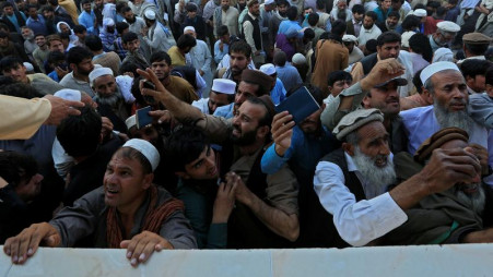 Afghan men wait to collect tokens needed to apply for the Pakistan visa, in Jalalabad, Afghanistan October 21, 2020. REUTERS/Parwiz