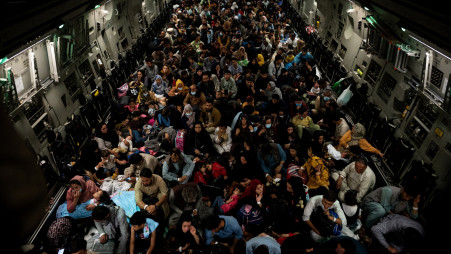 Evacuees from Afghanistan sit inside a military aircraft during an evacuation from Kabul, in this photo taken on August 19, 2021 at undisclosed location and released on August 20, 2021. Photo :Reuters