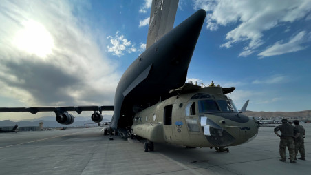 A CH-47 Chinook is loaded onto a U.S. Air Force C-17 Globemaster III at Hamid Karzai International Airport in Kabul, Afghanistan, August 28, 2021. The Chinook is one of the pieces of equipment returning to the U.S. as the military mission in Afghanistan comes to an end. Picture taken August 28, 2021. U.S. Central Command/Handout via REUTERS