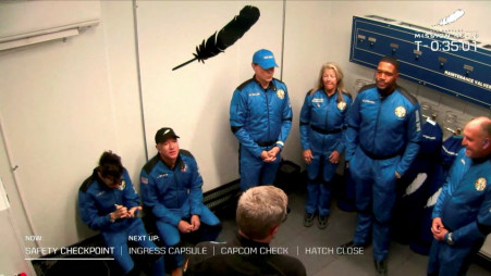 Billionaire Jeff Bezos, founder of ecommerce company Amazon.com Inc, sits with the crew of a scheduled flight before they board Blue Origin's New Shepard rocket near Van Horn, Texas, US on 11 December, 2021. Blue Origin/Handout via REUTERS.