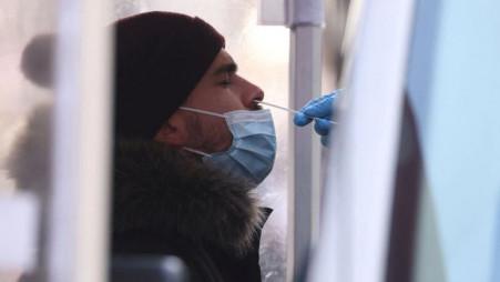 A person is tested for Covid-19 in Times Square as the Omicron coronavirus variant continues to spread in Manhattan, New York City, US, December 20, 2021.  Photo :Reuters