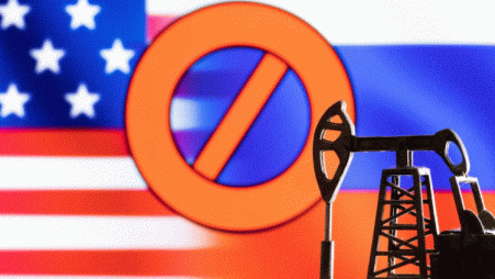 A model of a pump jack is seen in front of the displayed sign "stop", US and Russia flag colours in this illustration taken 8 March 2022. REUTERS/Dado Ruvic/Illustration