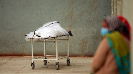 Relatives wait to receive the body of a man after he died from the coronavirus disease (COVID-19), outside a mortuary of a Covid-19 hospital in Ahmedabad, India, February 4, 2022. REUTERS/Amit Dave