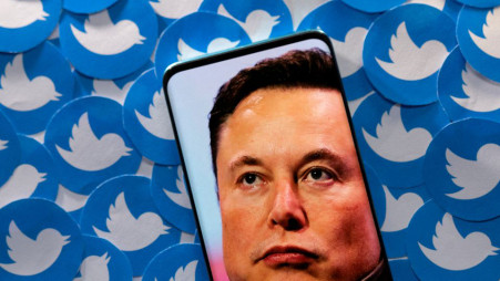 An image of Elon Musk is seen on smartphone placed on printed Twitter logos in this picture illustration taken April 28, 2022. REUTERS/Dado Ruvic/Illustration