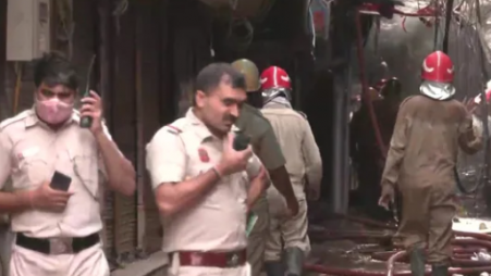 Firemen and Delhi police personnel in Gaffar market in Delhi's Karol Bagh