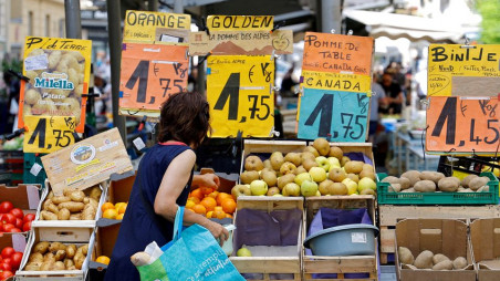 Price tags are seen as a woman shops at a local market in Nice, France, June 7, 2022. REUTERS/Eric Gaillard