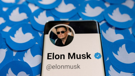 Elon Musk&#039;s Twitter profile is seen on a smartphone placed on printed Twitter logos in this picture illustration taken April 28, 2022. REUTERS/Dado Ruvic/Illustration