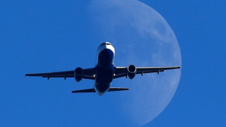 FILE PHOTO: A passenger plane is seen with the moon behind as it flies over London, Britain, January 4, 2020. REUTERS/Toby Melville