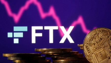 Representations of cryptocurrencies are seen in front of displayed FTX logo and decreasing stock graph in this illustration taken November 10, 2022. REUTERS/Dado Ruvic/Illustration/File Photo