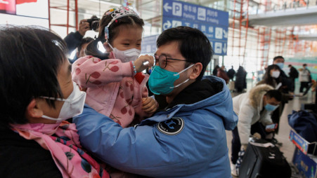 People hug at the international arrivals gate at Beijing Capital International Airport after China lifted the coronavirus disease (COVID-19) quarantine requirement for incoming travelers to Beijing, China, on January 8, 2023. REUTERS/Thomas Peter