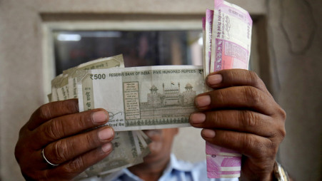 A cashier checks Indian rupee notes inside a room at a fuel station in Ahmedabad, India on 20 September 2018. File Photo: Reuters/Amit Dave