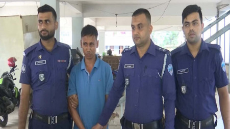 A handcuffed Arif Ullah pictured with police after he was arrested from the Bakkhali River jetty-6 in Cox's Bazar on 21 November. Photo: Courtesy