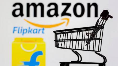 Small toy shopping cart is seen in front of displayed Amazon and Flipkart logos in this picture illustration taken, 30 July 2021. Photo: Reuters/Dado Ruvic