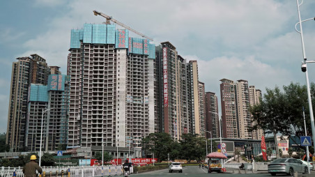 Sale signs adorn residential buildings under construction in Huizhou, Guangdong province, China October 10, 2024. Picture taken through a windshield. REUTERS/Nicoco Chan/File Photo