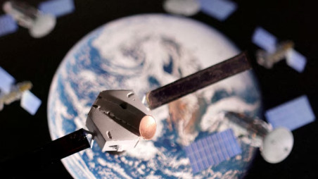 A satellite model is placed on a picture of Earth in this illustration taken November 25, 2024. Photo: REUTERS/Dado Ruvic/Illustration/File Photo