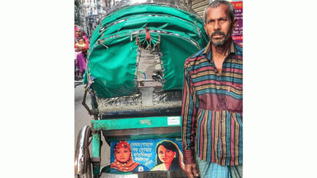 In 2020, Dhaka rickshaw puller Mohammad Shukkur displayed the slogan, “It’s not my clothes but your mentality that is to blame for rape” on his rickshaw. Despite criticism, he rode with it for over a year until it rusted off. Now, amid rising rape cases, he vows to restore it, renewing his call for change. Photo: Collected 