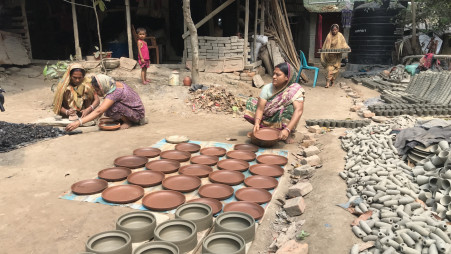 Earthen pots dried in the sun, dipped in colours, and burned. Potters in Bagerhat struggle to sustain amid decreasing demands. Photo: TBS