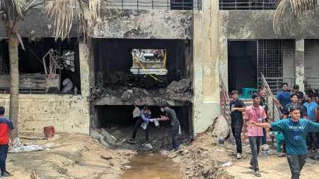 Volunteers collect and gather parts of the wrecked plane from the Milestone School and College grounds, a day after the devastating aircraft crash. Photo: Mehedi Hasan/TBS