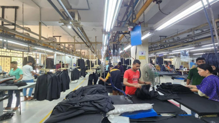 Workers craft suits at Thianis Apparels Limited—Chattogram’s first and only suit-manufacturing factory and a once-thriving Bangladesh–UK joint venture—now shuttered amid mounting financial distress and legal disputes with Bepza. Once exporting $10 million annually, the sealed facility lies silent, with 700 workers unpaid and $200,000 worth of garments trapped inside. Photo: Collected 
