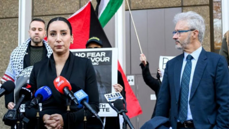 Journalist Antoinette Lattouf (centre) speaks to reporters during a doorstop at the Federal Court of Australia in Sydney. Photo: BSS/AFP