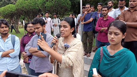A student addresses the issues and demands during the protest began around 11am in front of the university’s administration building. Photo: Collected