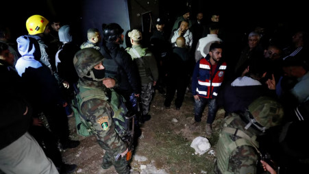 Palestinian security forces gather at the scene where Palestinian women were killed in an Iranian missile attack near Hebron in the Israeli-occupied West Bank on 18 March 2026. Photo: Reuters 