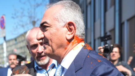 Reza Pahlavi is splattered with red liquid as he leaves a building after a news conference in Berlin yesterday, 23 April 2026. Photo: Collected