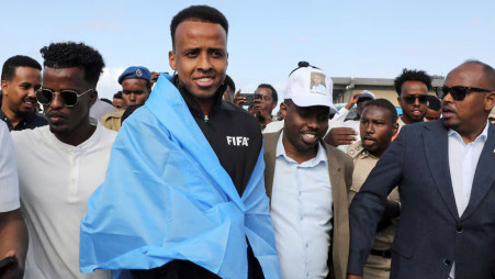 Somali referee Omar Abdulkadir Artan, who had been expected to officiate at matches during the 2026 FIFA World Cup but was denied entry to the United States, is received as he arrives at the Aden Abdulle Osman International Airport in Mogadishu, Somalia. Photo: Reuters
