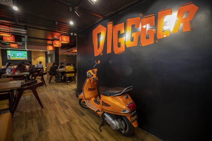 A bright orange Vespa parked near the entrance gives the interior a retro feel.  Photo: Noor A Alam / TBS