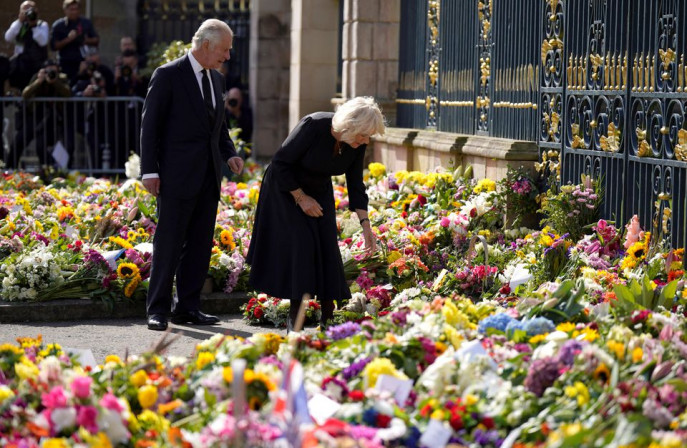 King Charles III and the Queen Consort view floral tributes left outside Hillsborough Castle, Co Down, following the death Queen Elizabeth II on Thursday. Picture date: Tuesday September 13, 2022. Niall Carson/Pool via REUTERS