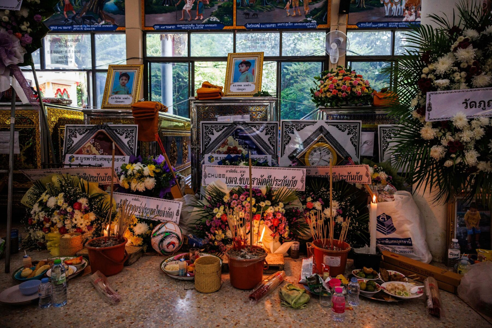 An October 2022 memorial in front of coffins at a temple in Nong Bua Lamphu, Thailand, where a former police officer killed 36 people, most of them children. Photographer: Andre Malerba
