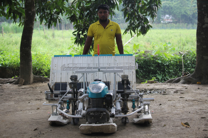Md Saiful Islam from Lama, Bandarban, with his rice transplanter.  In addition to cultivating three acres of his own land, he provides machinery services on 40 acres in the neighborhood, benefiting about 15 farmers.  Photo: Courtesy