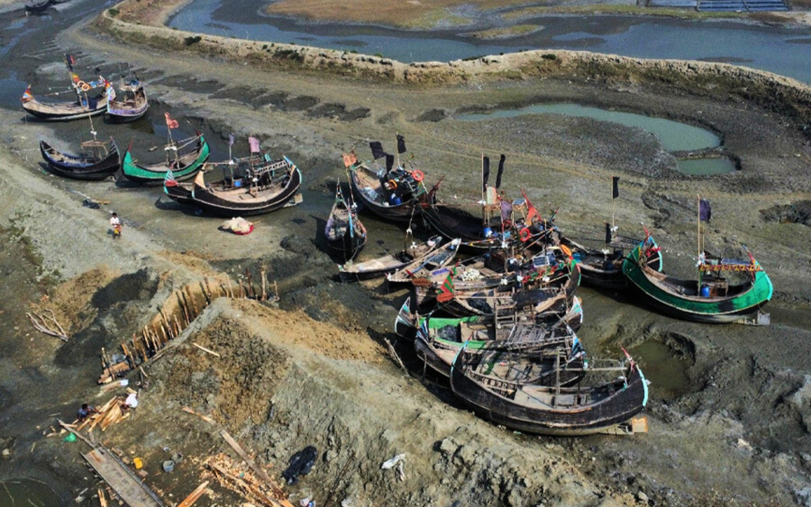 A bird-eye view captures coastal lands adorned with parked boats. Photo: Md  Emon Rahman