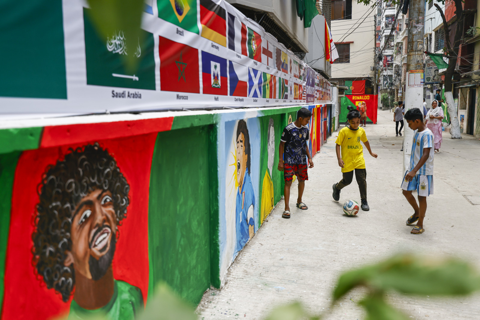 An alley on KM Das Lane, now known as “FIFA Goli”, has transformed into a vibrant hub of football fever, with local children embracing a month of World Cup-inspired excitement. Photos: Rajib Dhar
