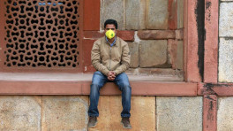 FILE PHOTO: A tourist wearing a protective mask is seen at Humayun's Tomb in New Delhi, India March 6, 2020. REUTERS/Anushree Fadnavis