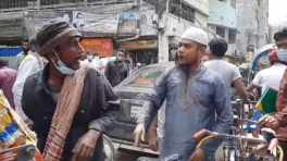 The man, wearing a panjabi and prayer cap, swooped on the rickshaw puller and started to hit him. At one stage, the rickshaw puller fell down on the road. May 4, 2021. Photo: Taken from a video