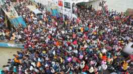 Commuters throng at the Mawa ferry ghat where only a few ferries were allowed to cross the Padma River to carry the ambulances on a limited scale. Photo: Salahuddin Ahmed/TBS