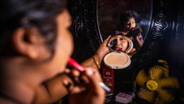 A young girl is seen putting on makeup at Daulatdia brothel. Photo credit: Salauddin Ahmed
