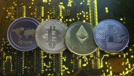 Representations of the Ripple, Bitcoin, Etherum and Litecoin virtual currencies are seen on a PC motherboard in this illustration picture, February 14, 2018. REUTERS/Dado Ruvic/Illustration