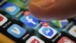 A smartphone displays the apps for Facebook and Messenger in New Orleans, Aug. 11, 2019. The European Union on Wednesday targeted Apple, Amazon, Microsoft, Google parent Alphabet, Facebook owner Meta and TikTok parent ByteDance under new digital rules aimed at reining in the market power of online companies. (AP Photo/Jenny Kane, File)
