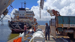 Caption: Labourers unload rice bags from a supply truck at India's main rice port at Kakinada Anchorage in the southern state of Andhra Pradesh, India.
