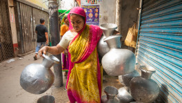 A woman walks back with empty pitchers after finding no water at the roadside tap provided by WASA in Pannitola, Old Dhaka, on Saturday. Many parts of the capital are experiencing water shortages because the ongoing heatwave is lowering groundwater levels. Photo: Rajib Dhar