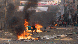 A picketer throws a plastic chair in the fire during a recent clash between quota reform protesters and law enforcement agencies. Courtesy: File Photo.  